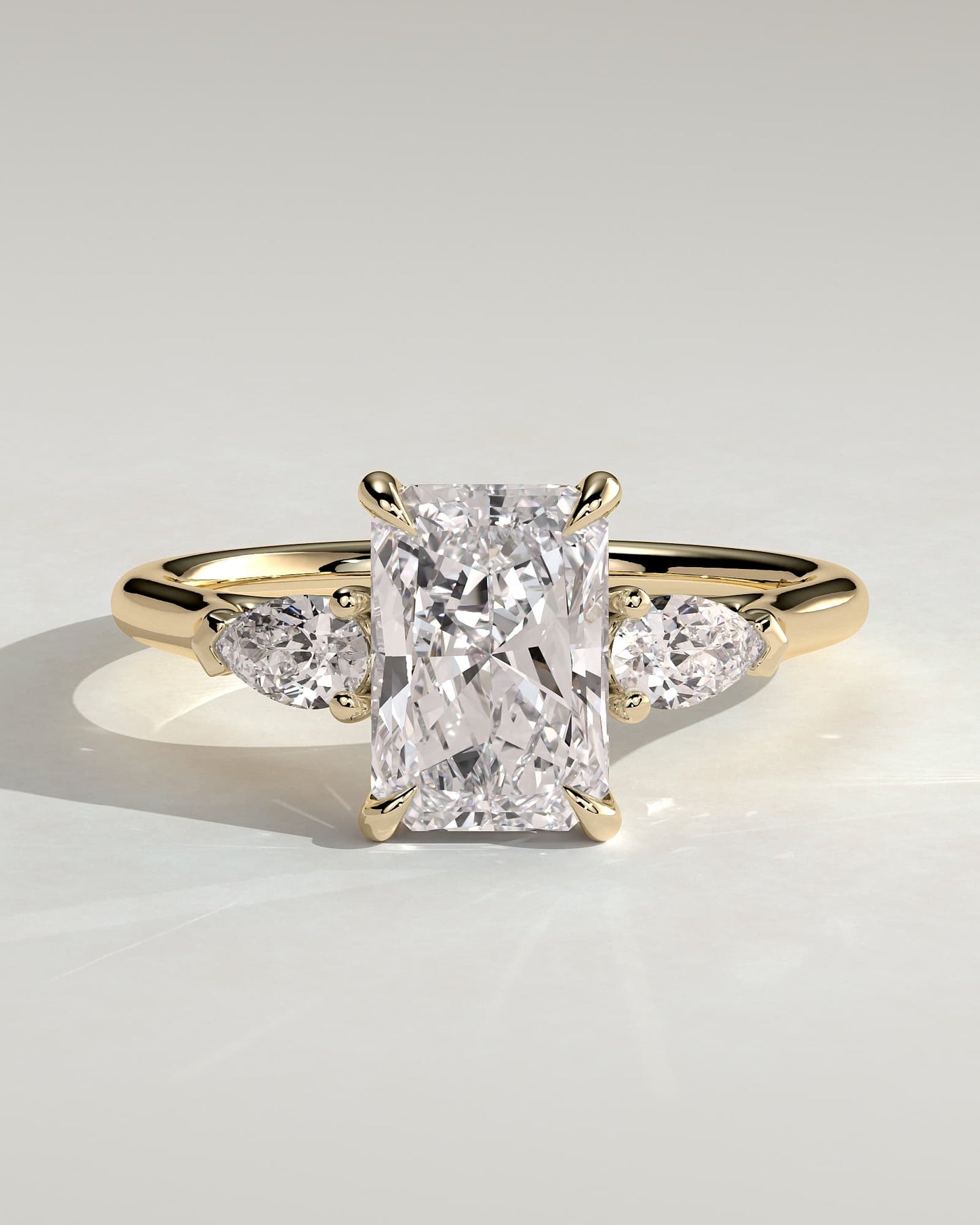 Jasmine - Radiant Claw Trilogy with Pear Side Stones and Cathedral Setting Engagement Ring - Yellow Gold