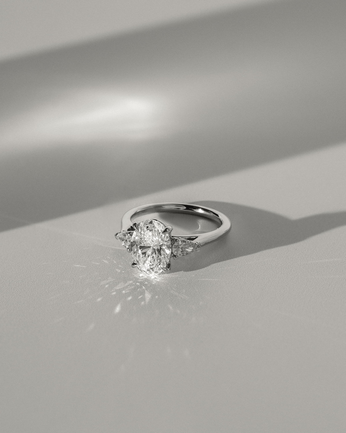 Alexia - Oval Claw Trilogy with Pear Side Stones and Cathedral Setting Engagement Ring - Yellow Gold