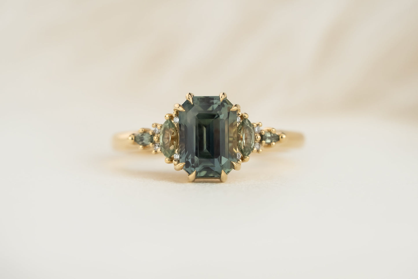 The Maeve Ring | 2.59 CT Emerald Cut Teal Sapphire + Green Sapphire Accents