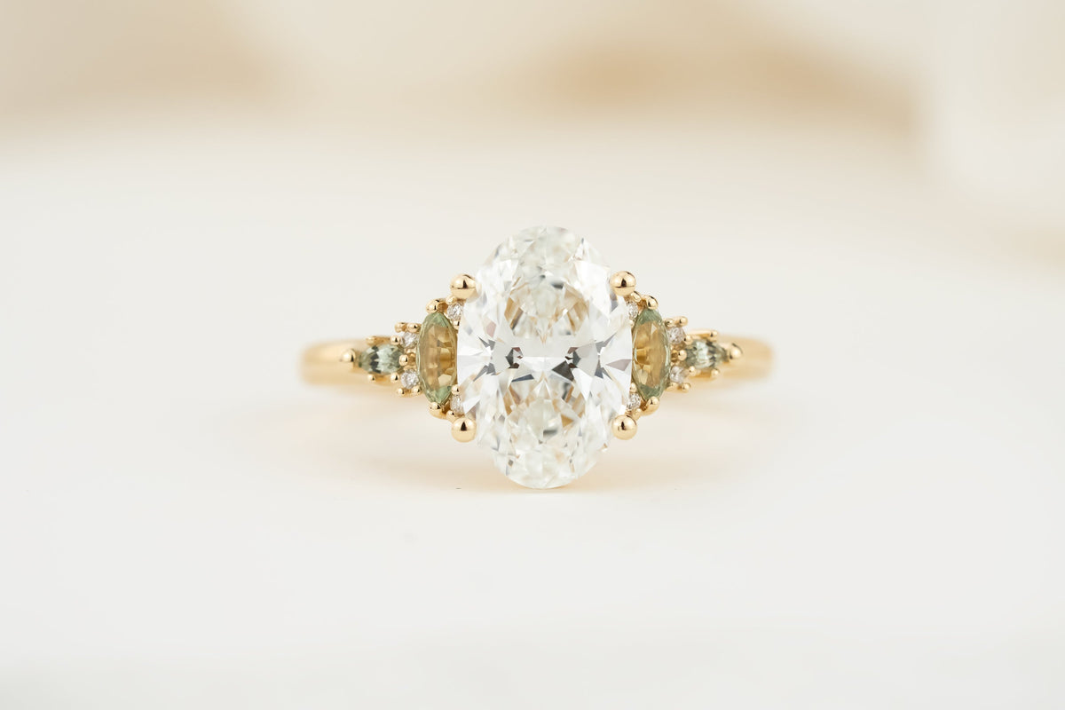 the-maeve-ring-2-07-ct-oval-diamond-light-green-sapphire-accents