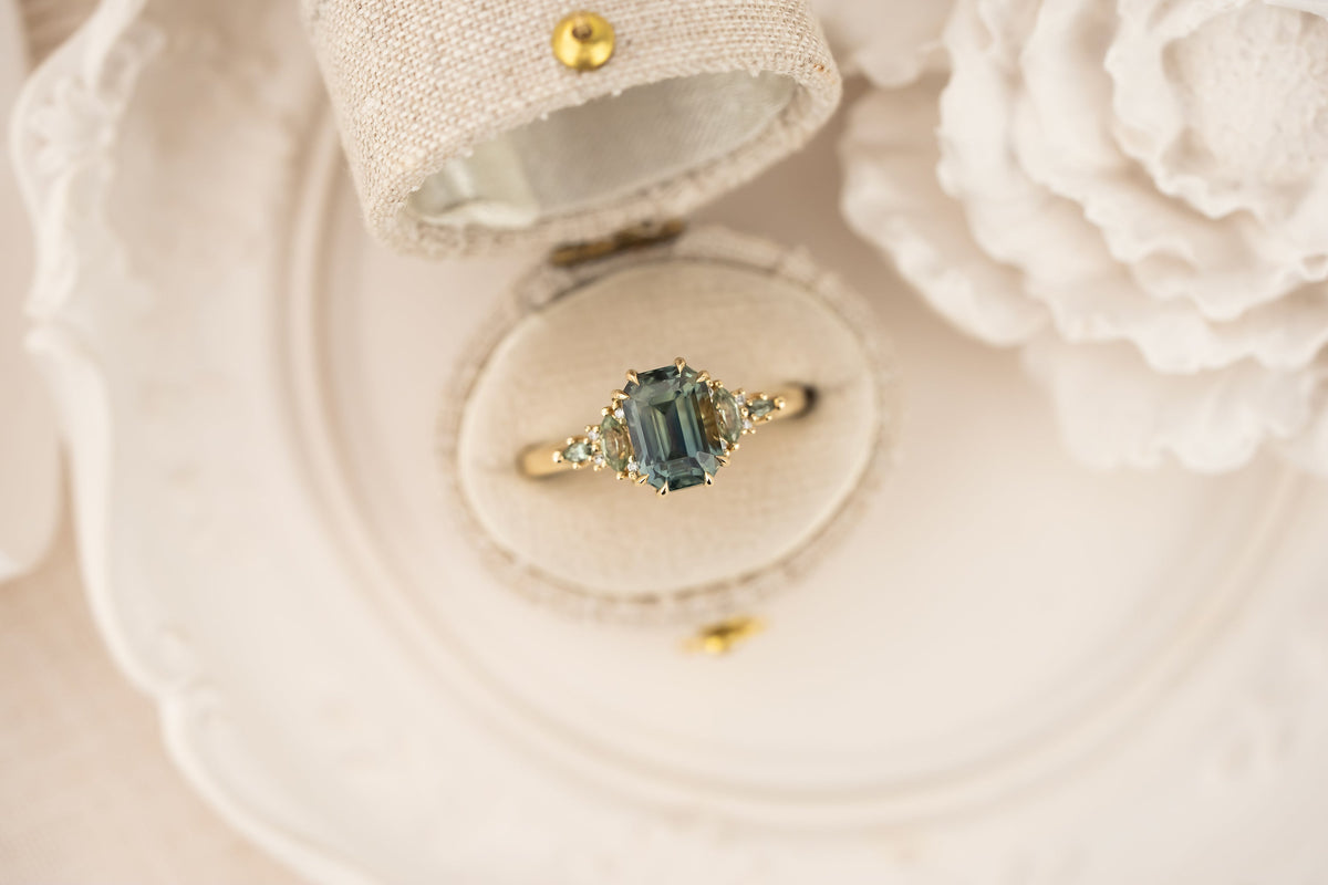 the-maeve-ring-2-59-ct-emerald-cut-teal-sapphire-green-sapphire-accents