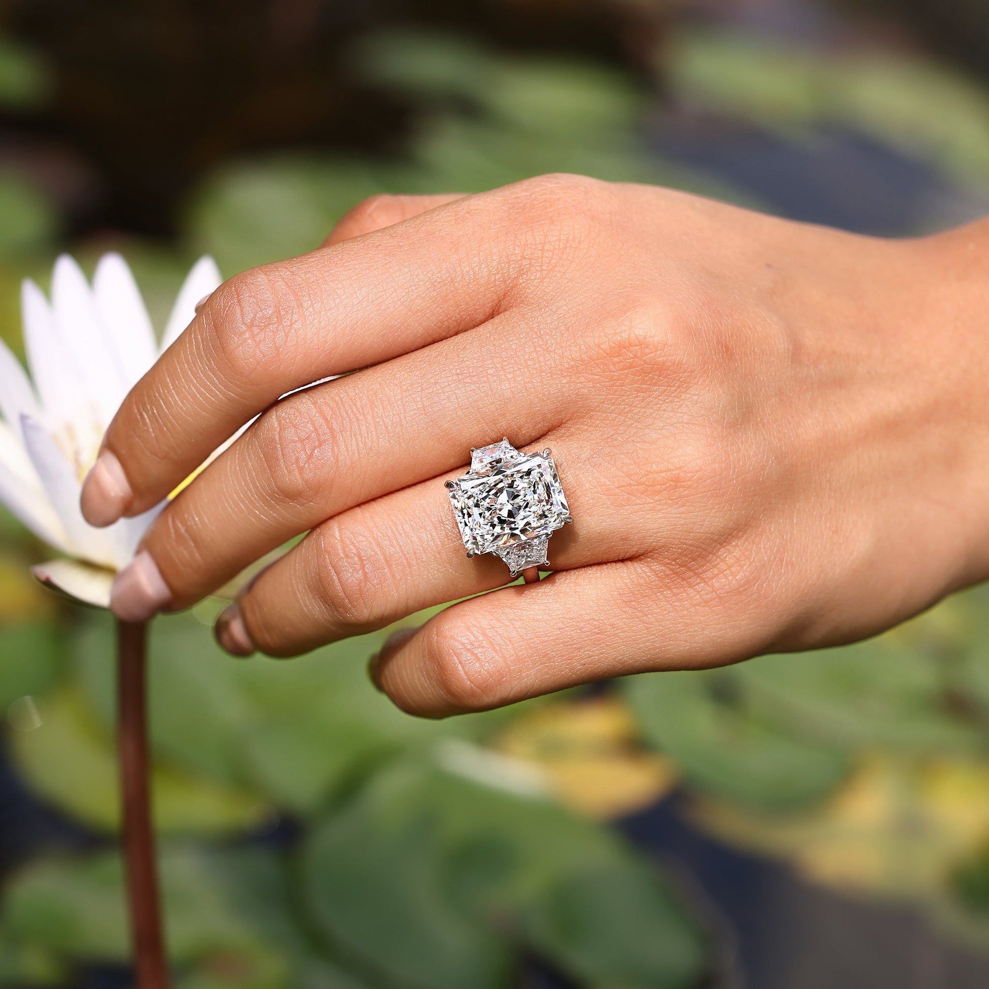 10 - 14 Carat Radiant Cut Diamond Ring with Trapezoid Side Stones