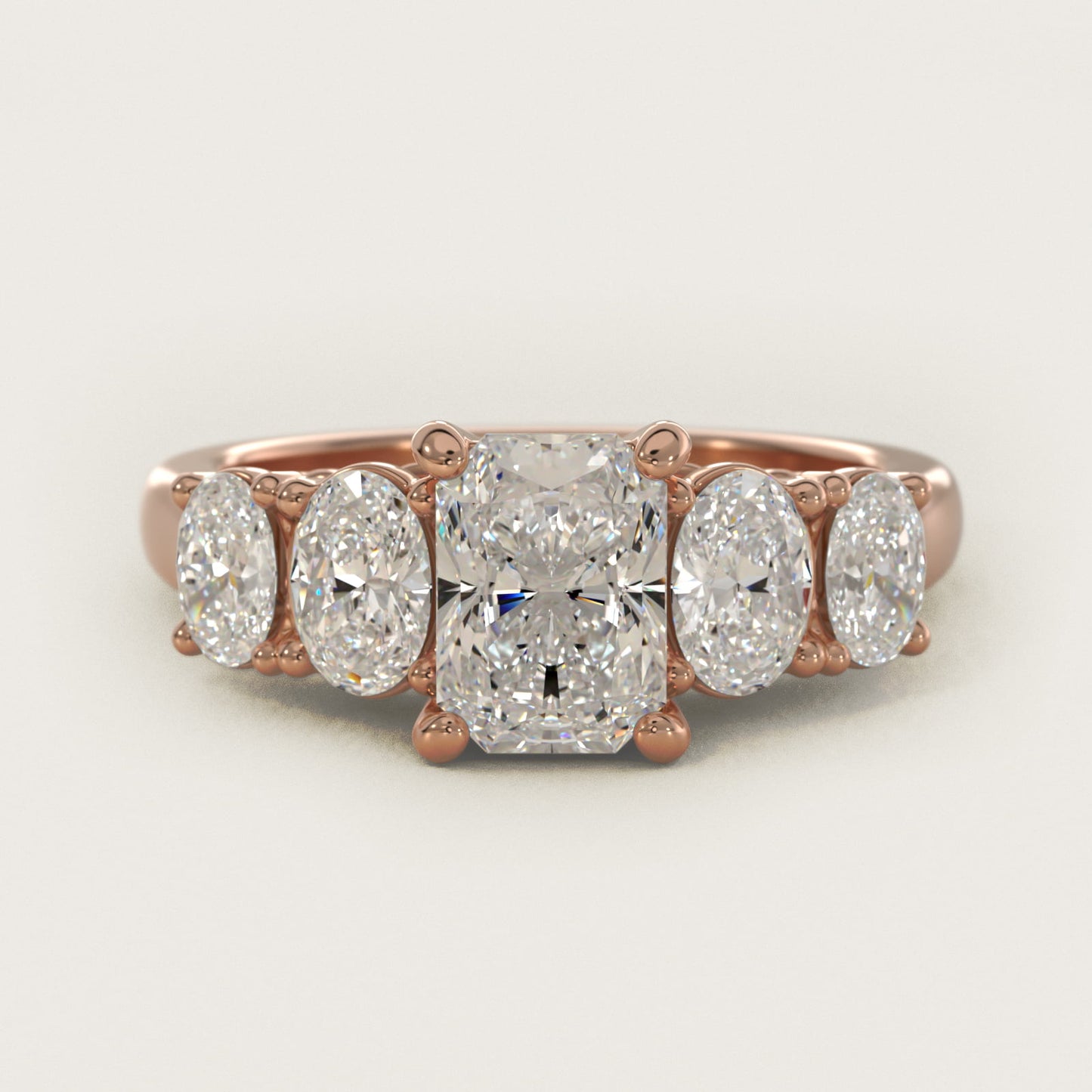 Graduated Oval Diamond Engagement Ring in 14k Rose Gold (1/2 ct. tw.) - Radiant Center