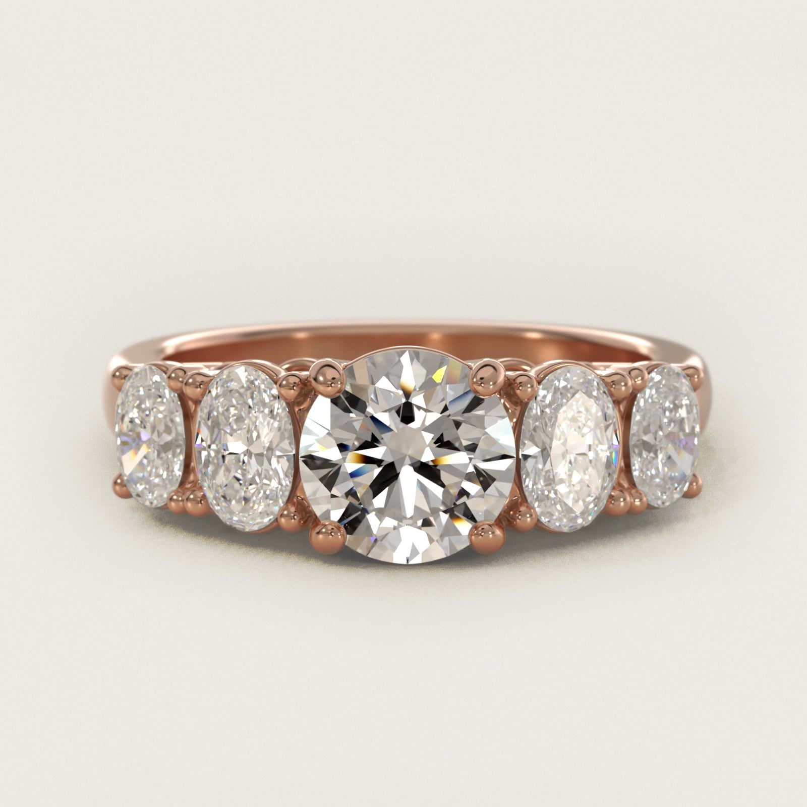 Graduated Oval Diamond Engagement Ring in 14k Rose Gold (1/2 ct. tw.) - Round Center