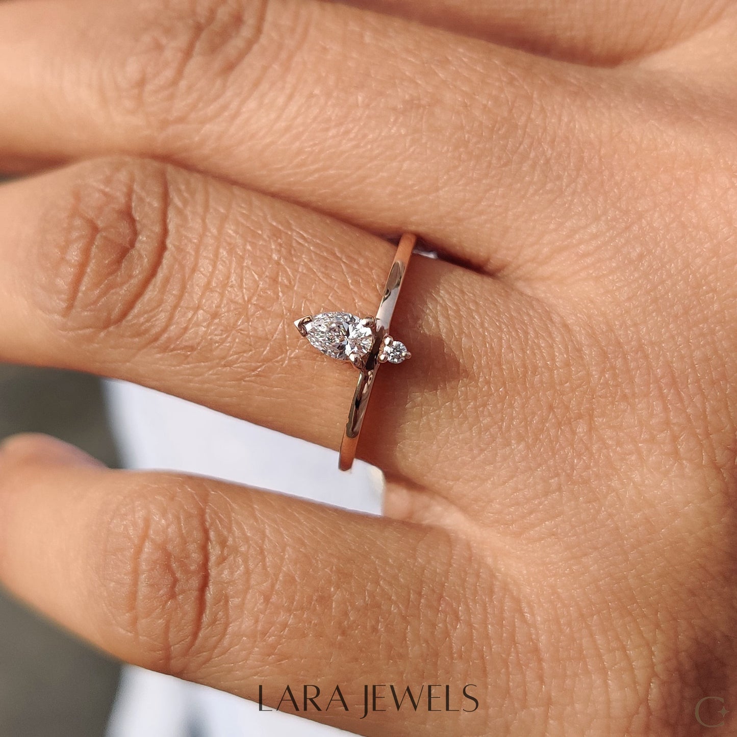 Lab grown round engagement ring in Pear and Round Diamond, available in Silver. IGI certified, ethically sourced, handcrafted at Lara Jewels.