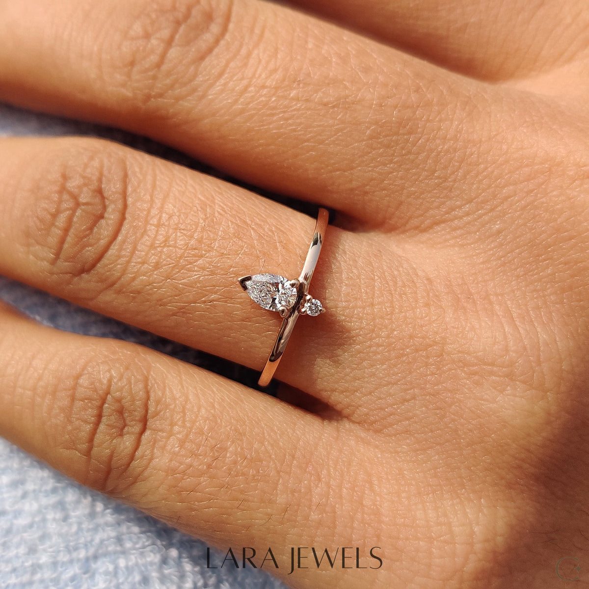 Lab grown round engagement ring in Pear and Round Diamond, available in Silver. IGI certified, ethically sourced, handcrafted at Lara Jewels.