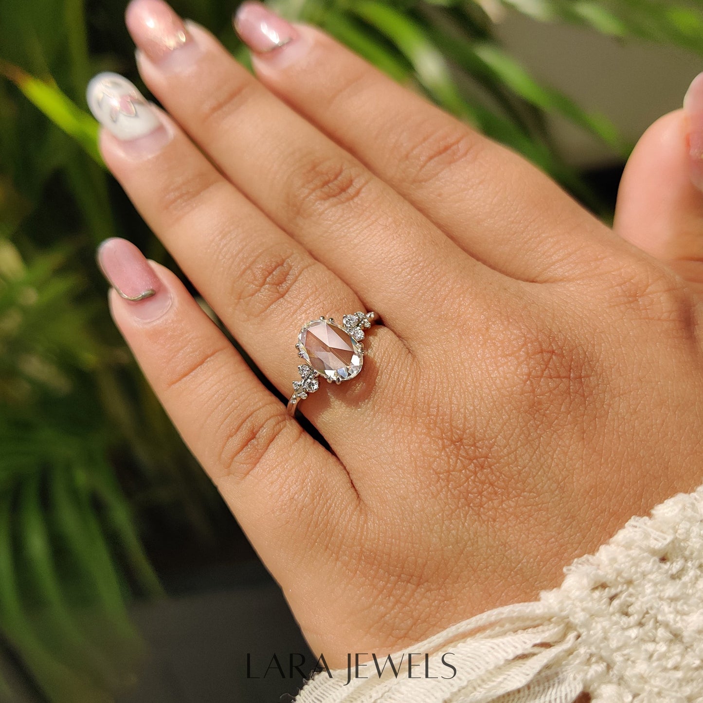 Lab grown oval engagement ring in Cluster Setting, available in Silver. IGI certified, ethically sourced, handcrafted at Lara Jewels.