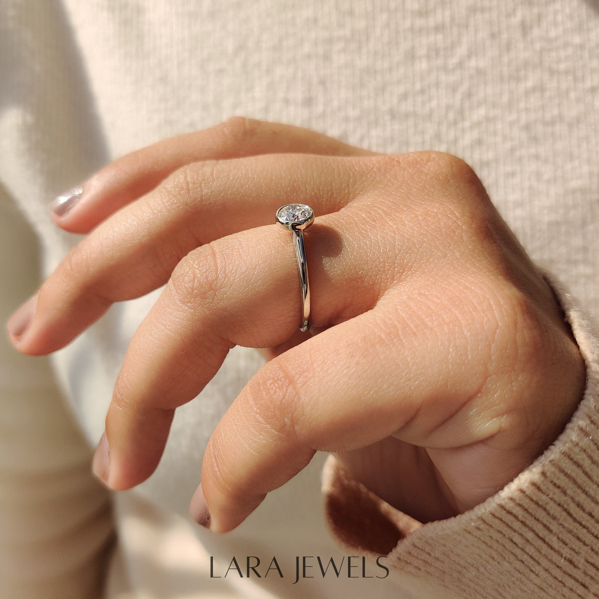 Lab grown round engagement ring in Bezel Solitaire Setting, available in Silver. IGI certified, ethically sourced, handcrafted at Lara Jewels.
