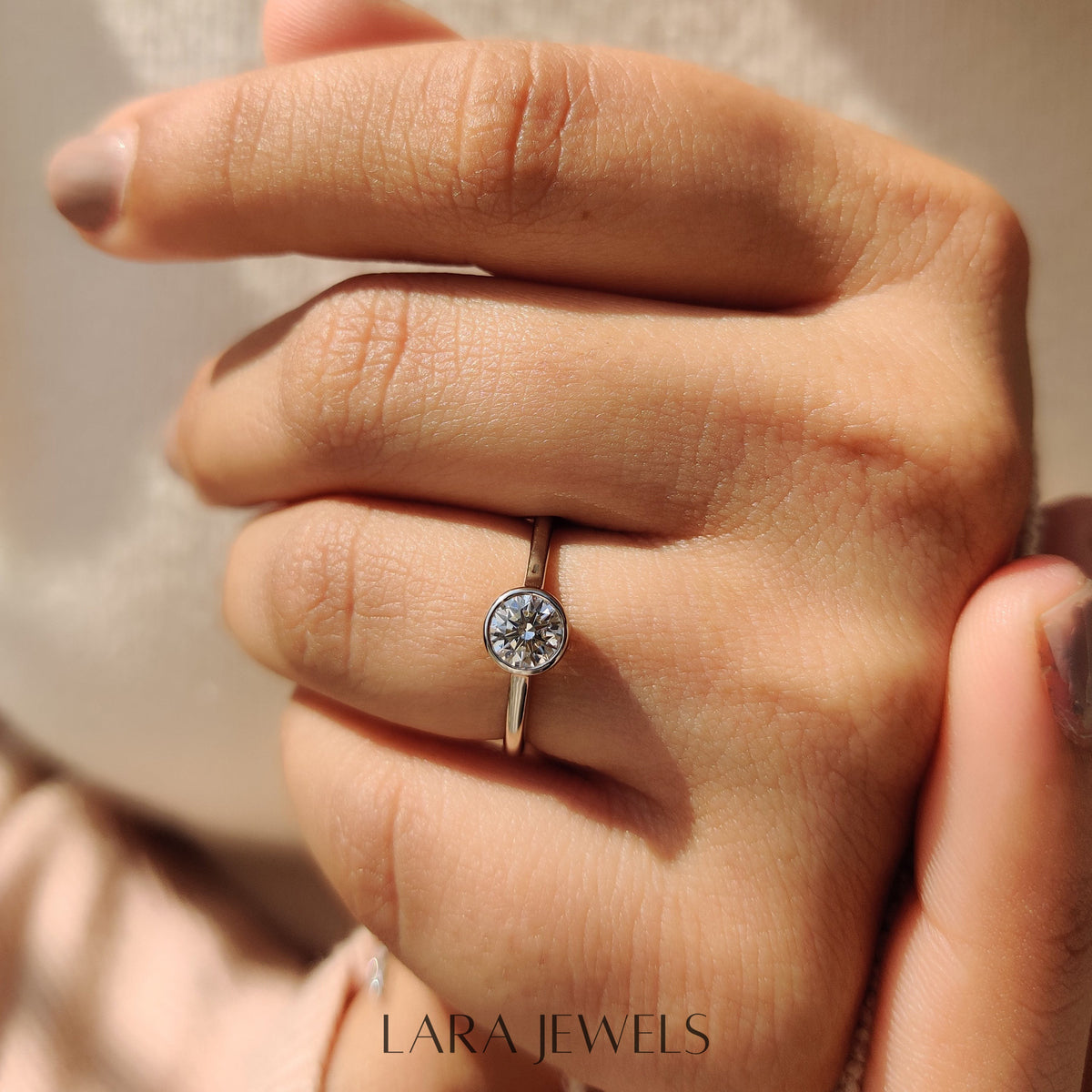 Lab grown round engagement ring in Bezel Solitaire Setting, available in Silver. IGI certified, ethically sourced, handcrafted at Lara Jewels.
