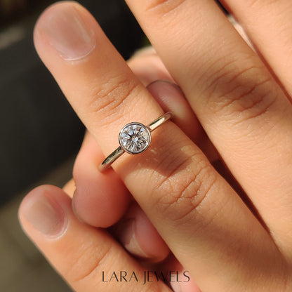 Lab grown round engagement ring in Bezel Solitaire Setting, available in Silver. IGI certified, ethically sourced, handcrafted at Lara Jewels.