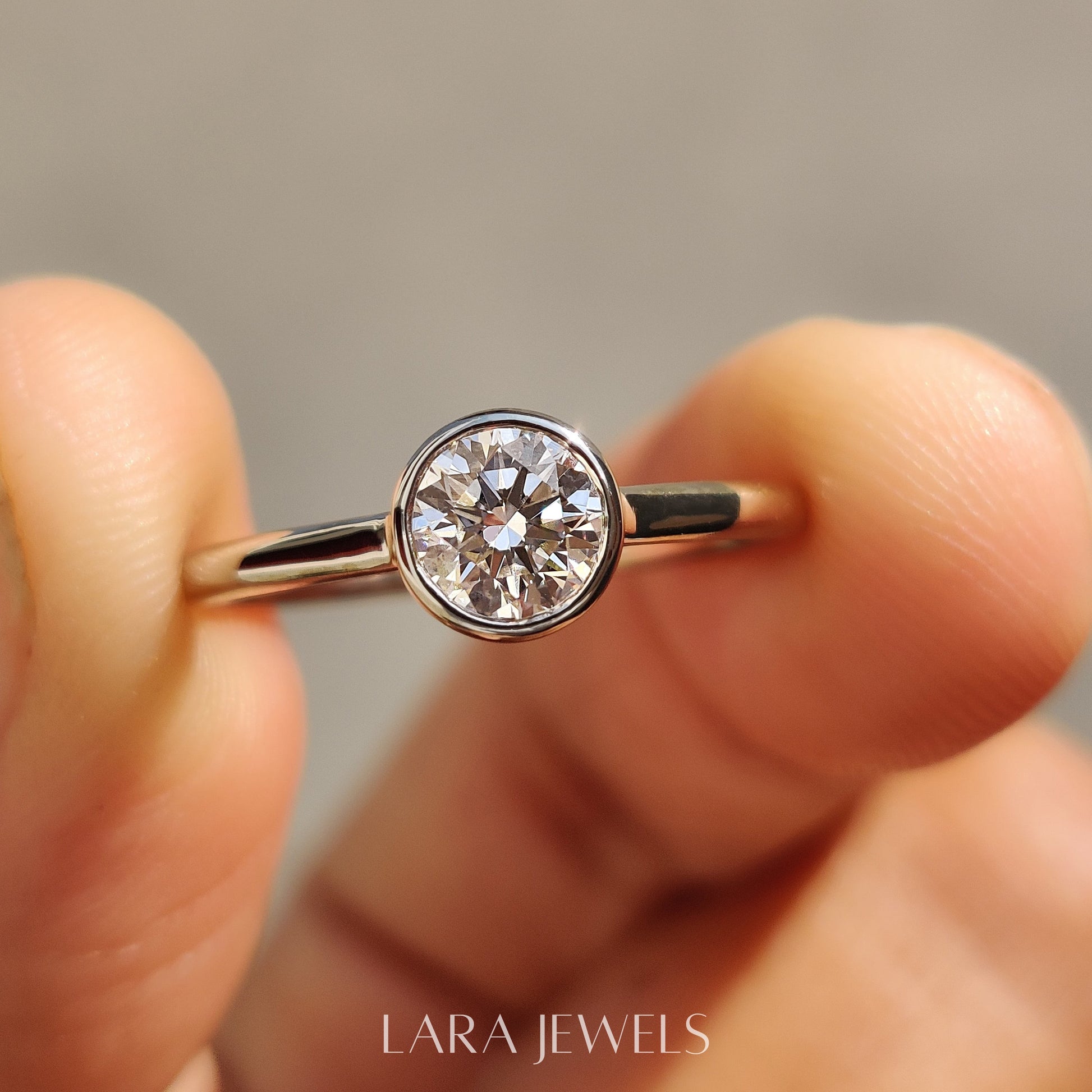 Lab grown round engagement ring in Bezel Solitaire Setting, available in Silver. IGI certified, ethically sourced, handcrafted at Lara Jewels.