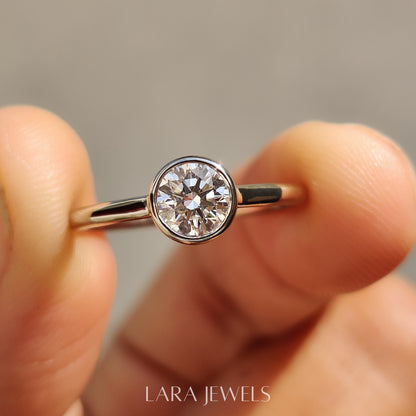 Lab grown round engagement ring in Bezel Solitaire Setting, available in Silver. IGI certified, ethically sourced, handcrafted at Lara Jewels.
