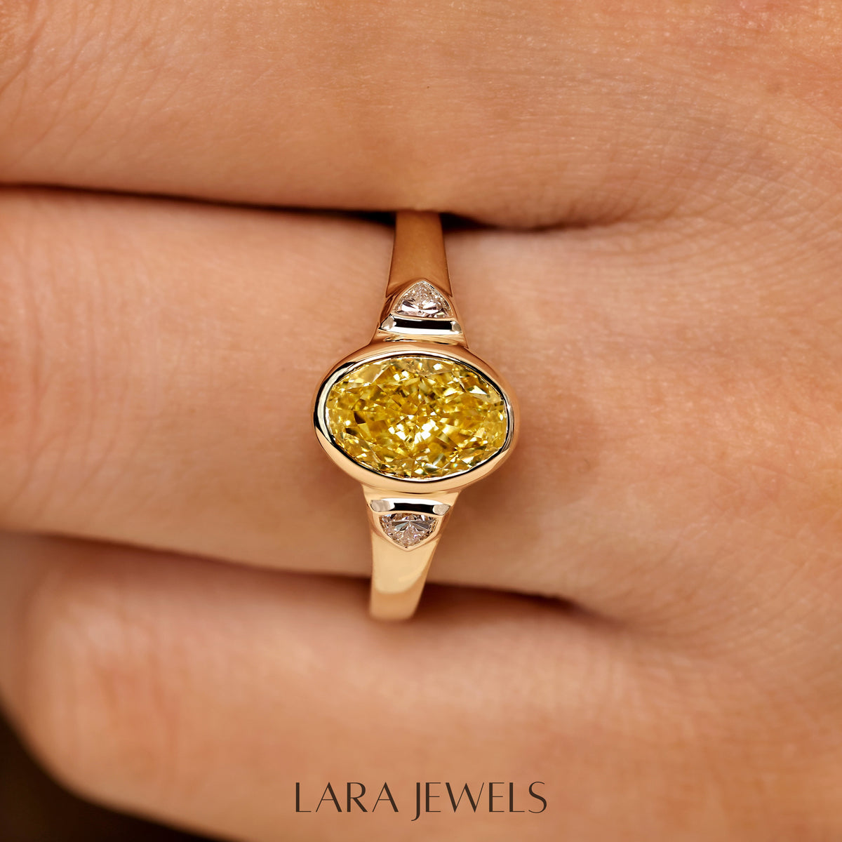 Lab grown oval engagement ring in Trillion Side Stone, available in Silver. IGI certified, ethically sourced, handcrafted at Lara Jewels.