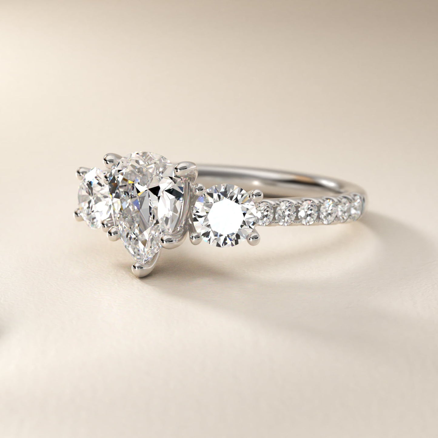 Modern Trellis Three Stone Diamond Engagement in Platinum - Pear Center