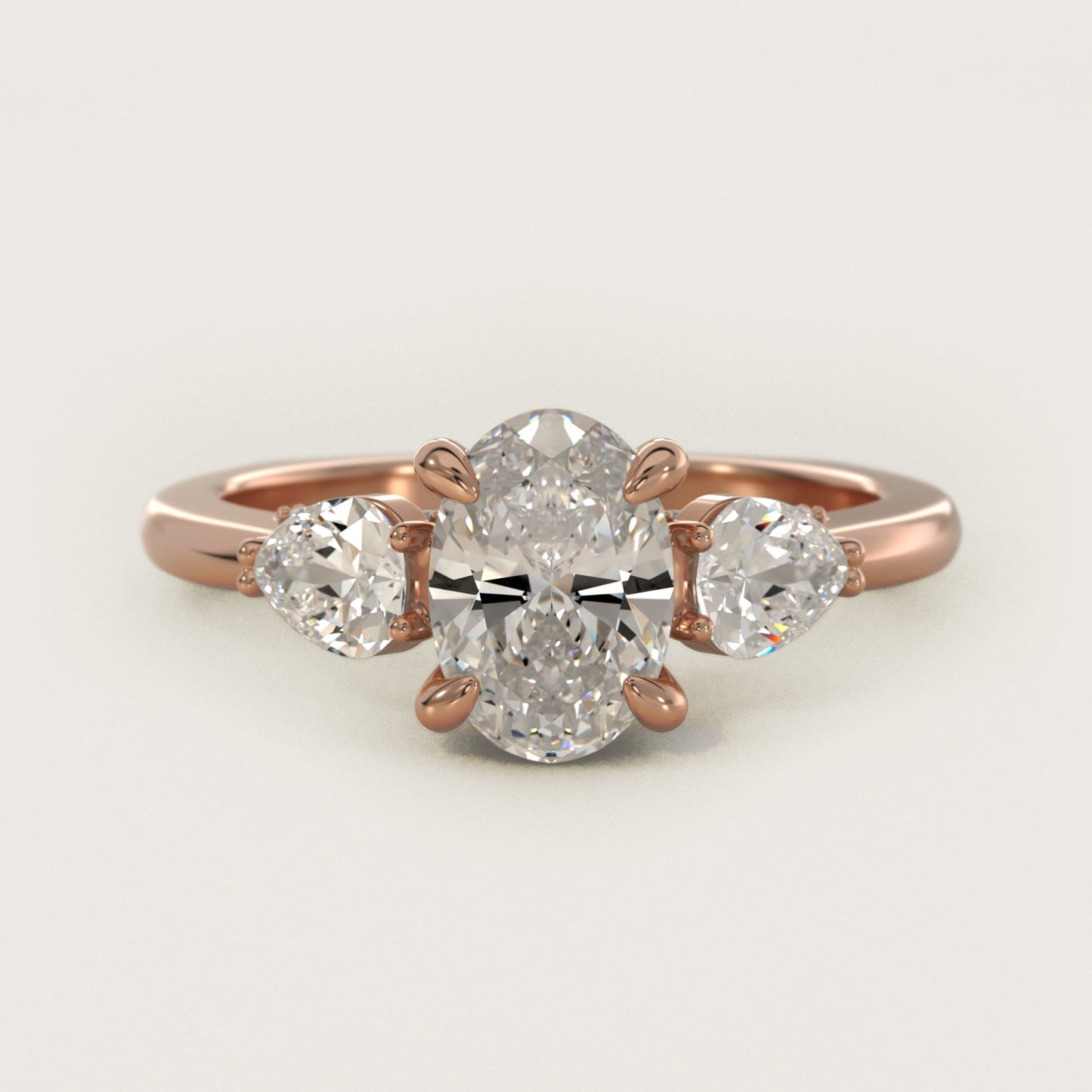 Pear Three Stone Engagement Ring in 14k Rose Gold (5/8 ct. tw.) By Bella Vaughan - Oval Center