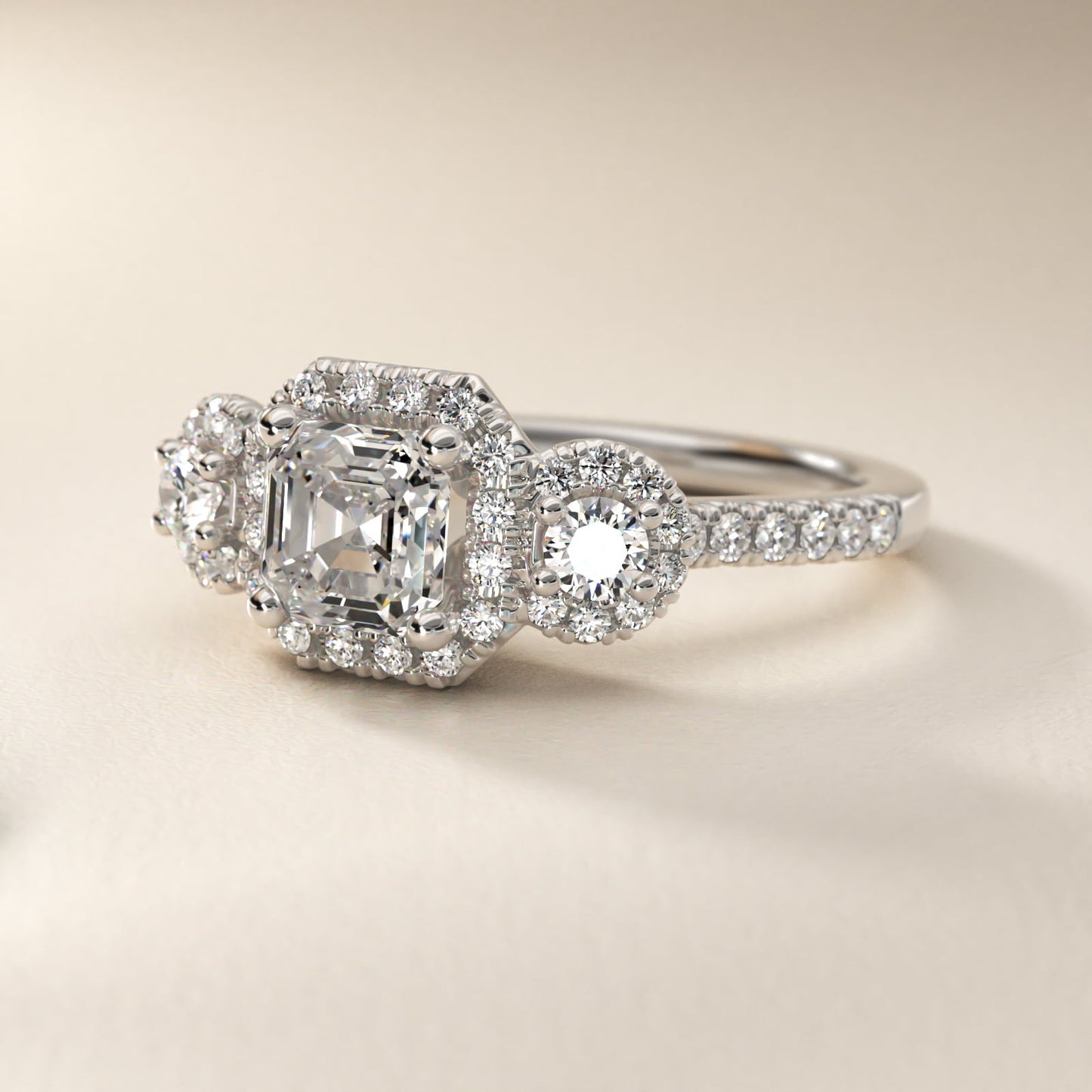 Three-Stone Halo Diamond Engagement Ring in Platinum - Asscher Center