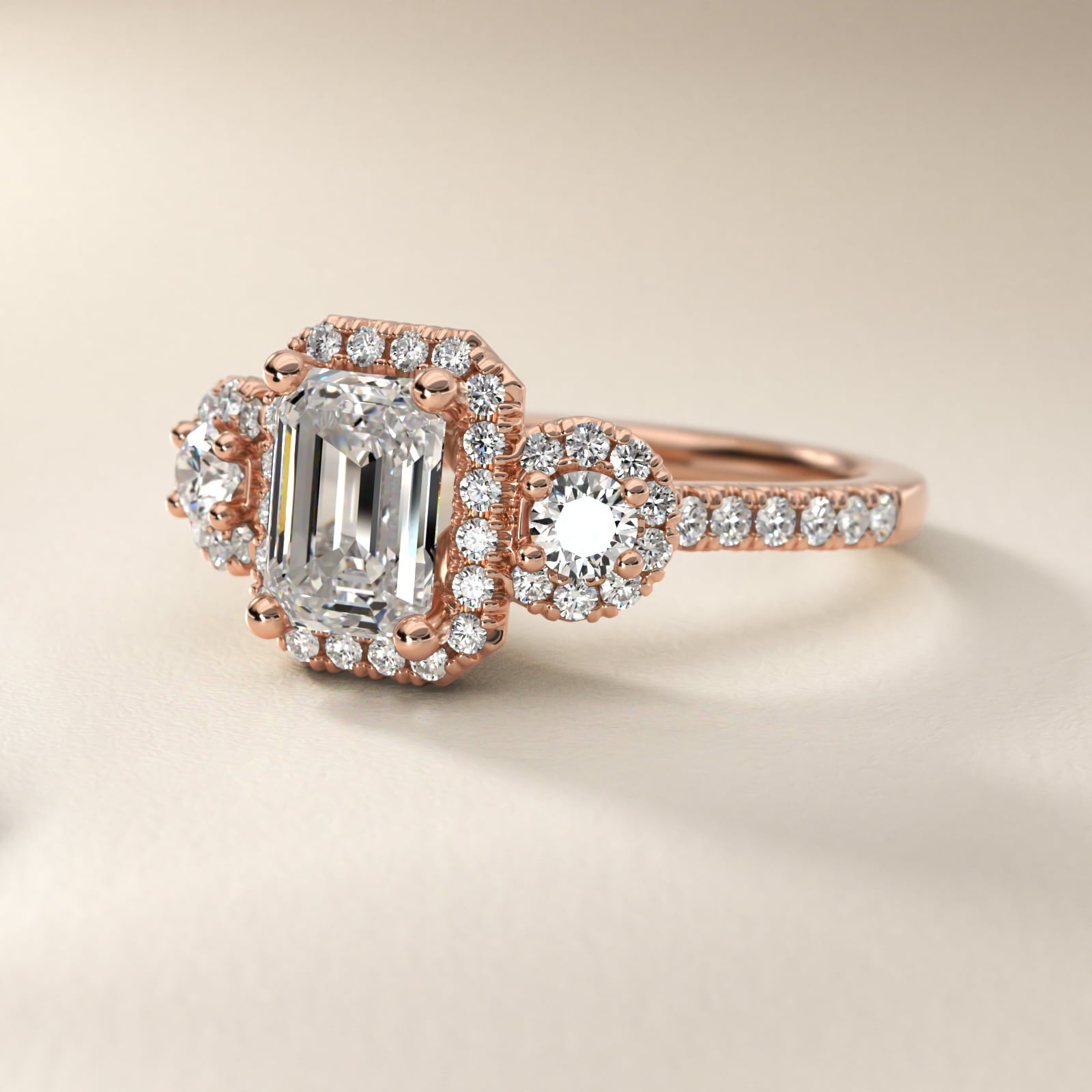 Three-Stone Halo Diamond Engagement Ring in 18k Rose Gold - Emerald Center