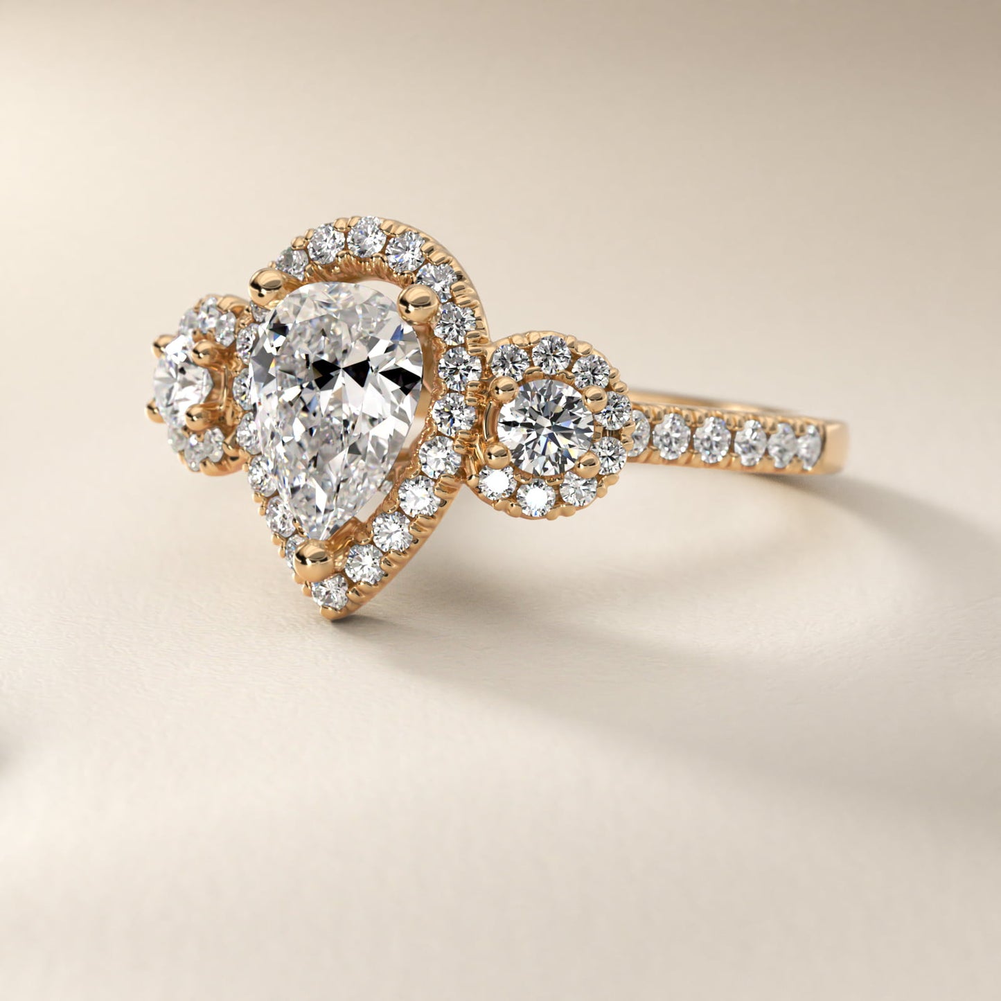Three-Stone Halo Diamond Engagement Ring in 18k Yellow Gold - Pear Center