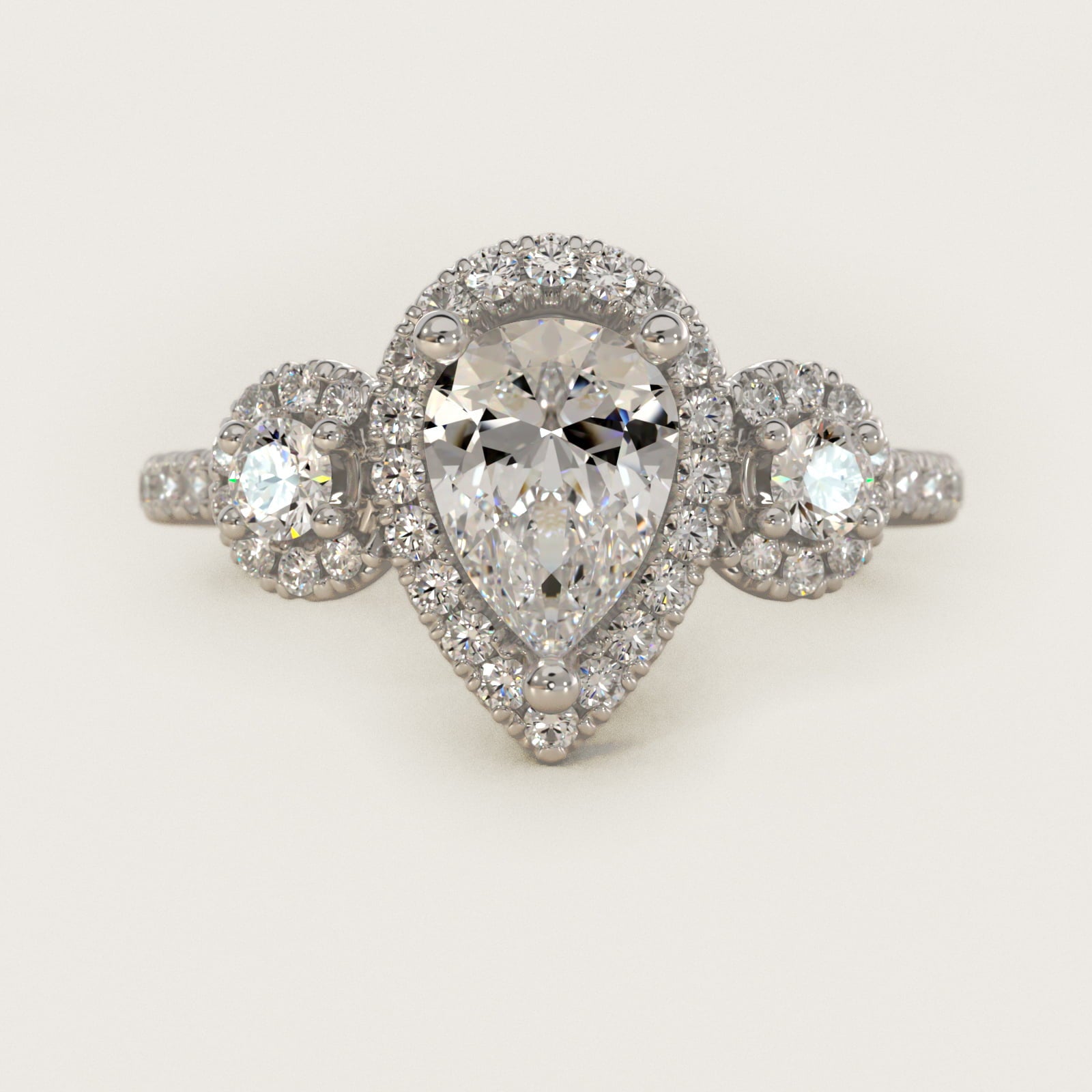 Three-Stone Halo Diamond Engagement Ring in Platinum - Pear Center