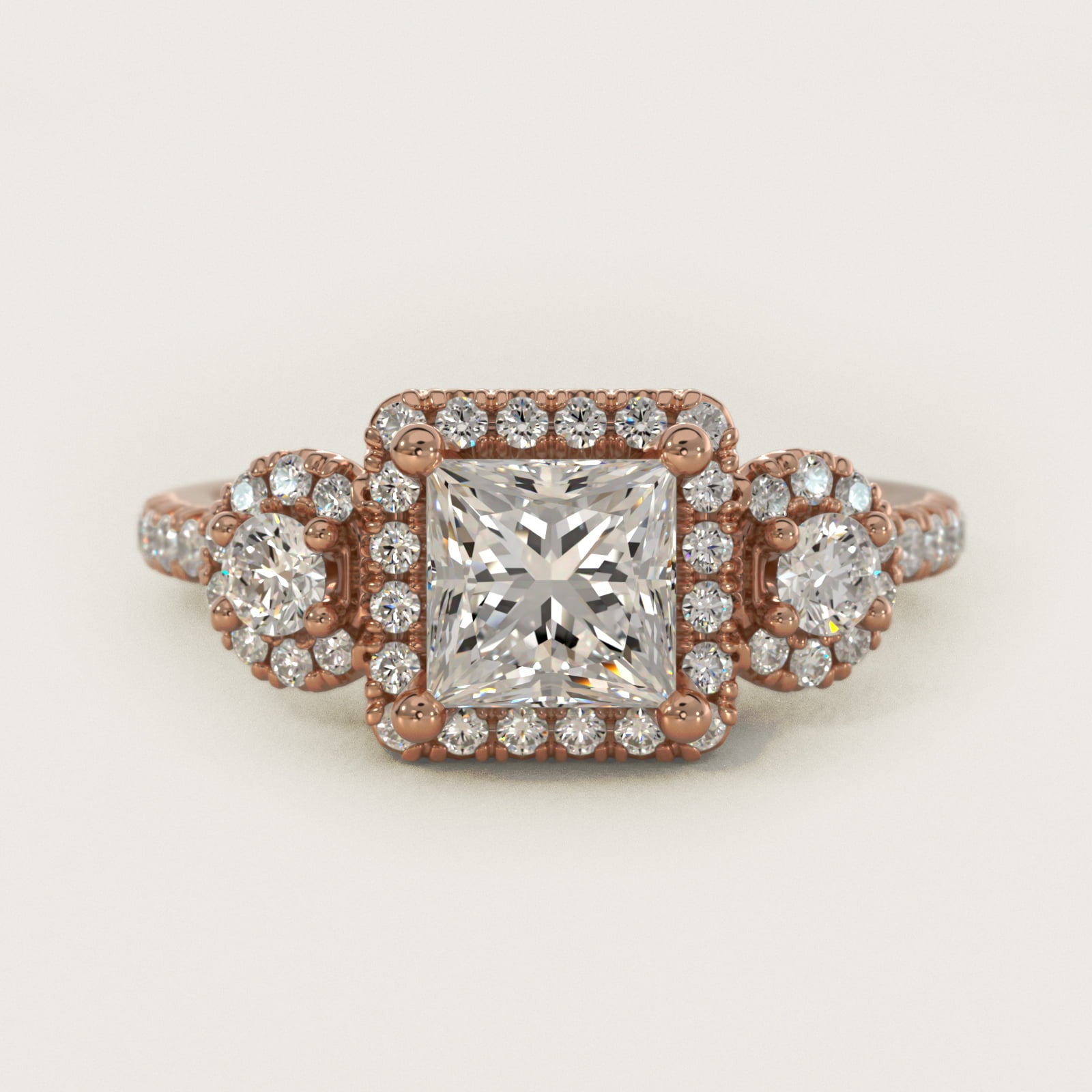 Three-Stone Halo Diamond Engagement Ring in 18k Rose Gold - Princess Center
