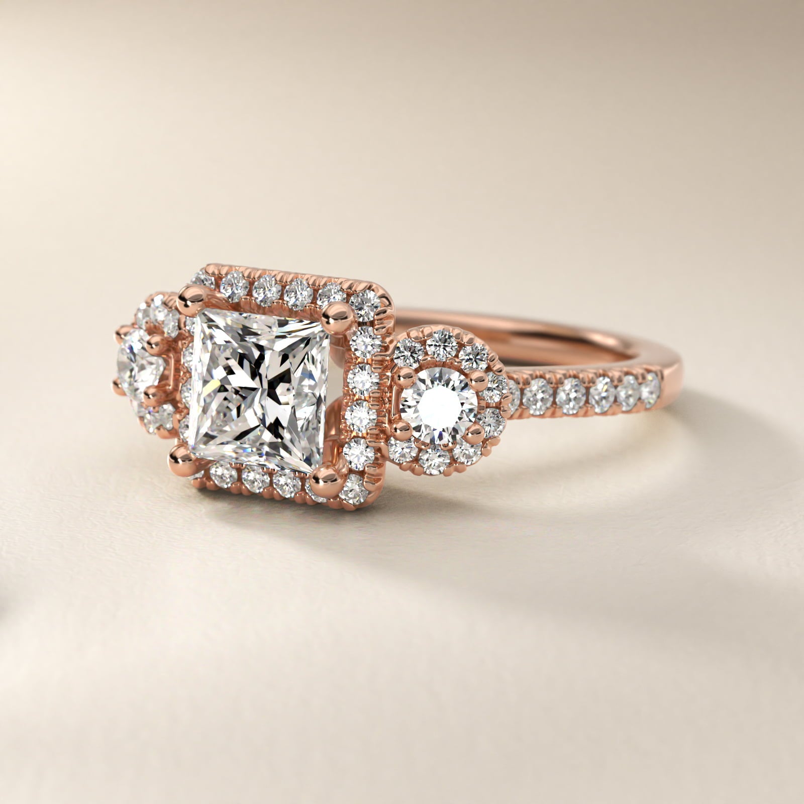 Three-Stone Halo Diamond Engagement Ring in 18k Rose Gold - Princess Center