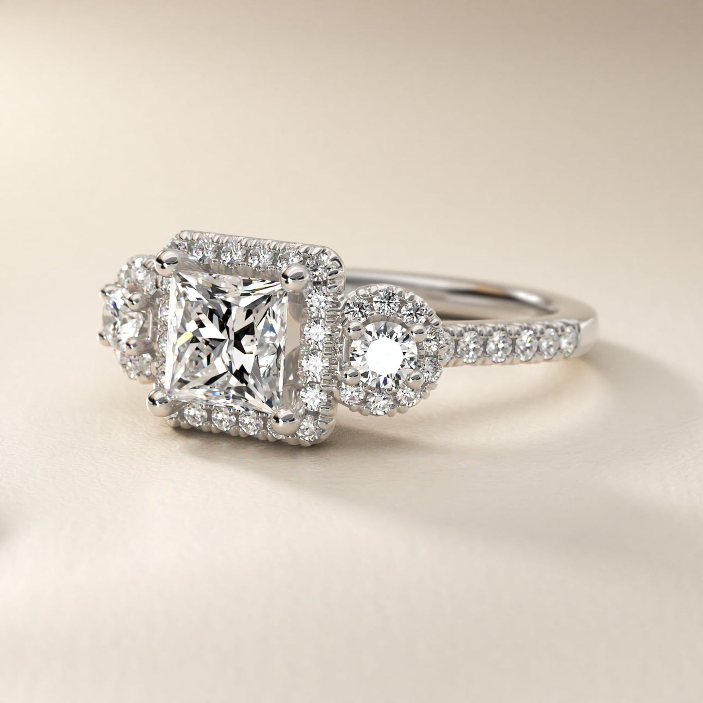 Three-Stone Halo Diamond Engagement Ring in Platinum - Princess Center
