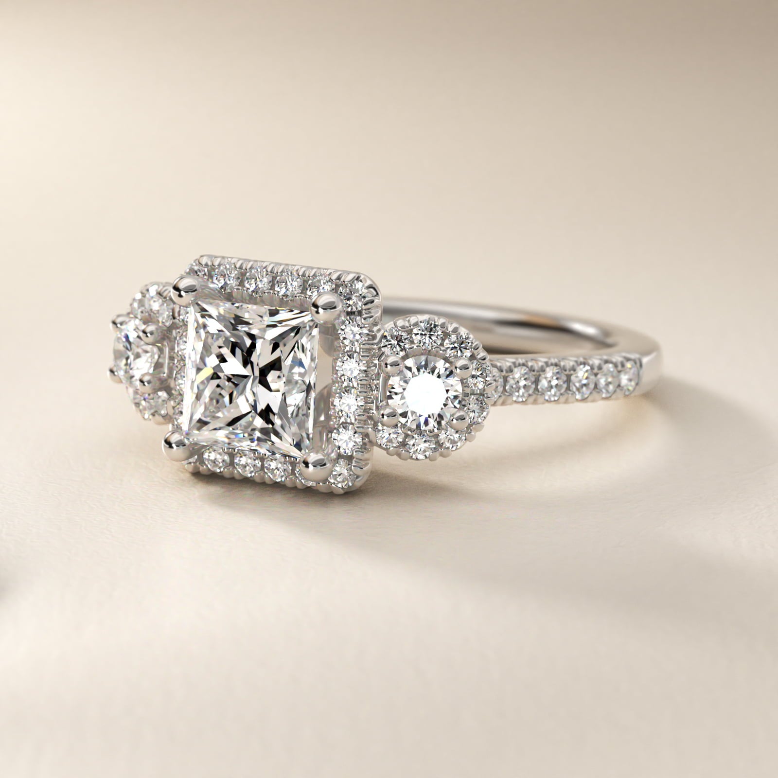 Three-Stone Halo Diamond Engagement Ring in Platinum - Princess Center