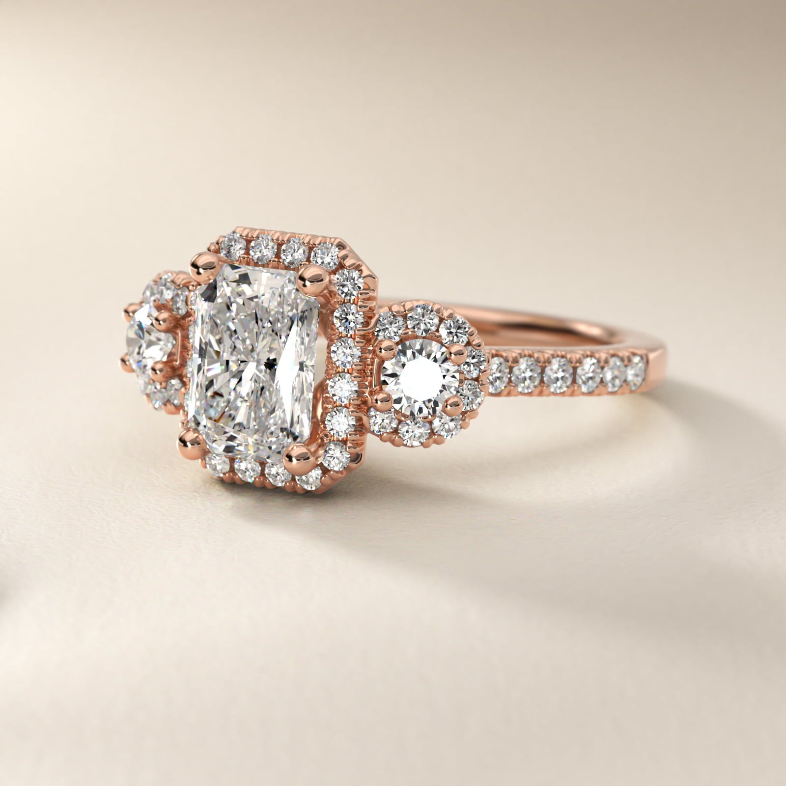 Three-Stone Halo Diamond Engagement Ring in 18k Rose Gold - Radiant Center