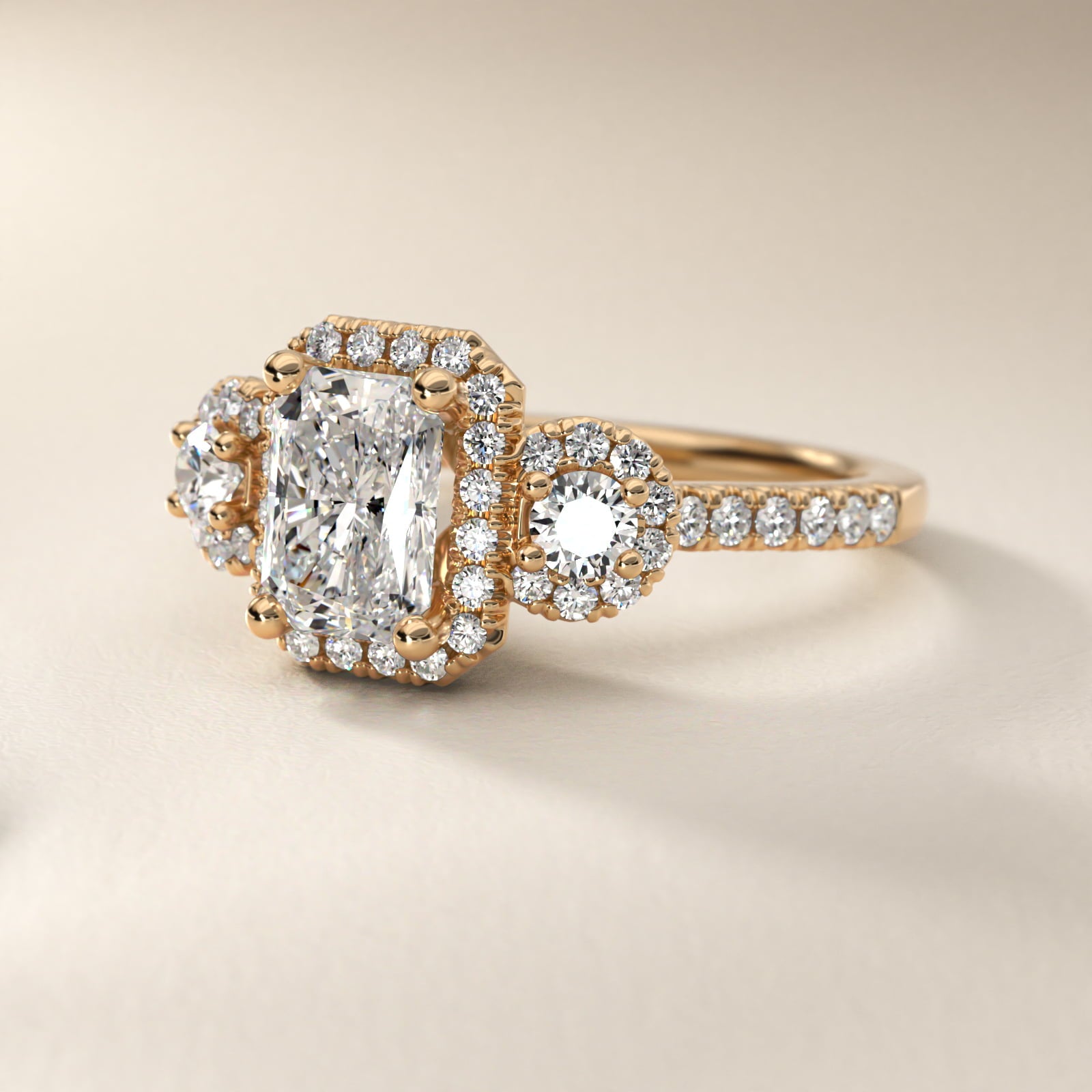 Three-Stone Halo Diamond Engagement Ring in 14k Yellow Gold - Radiant Center