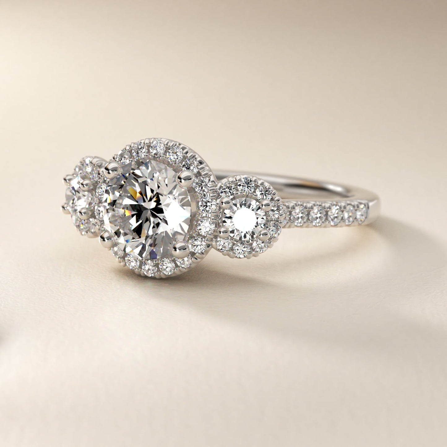 Three-Stone Halo Diamond Engagement Ring in Platinum - Round Center