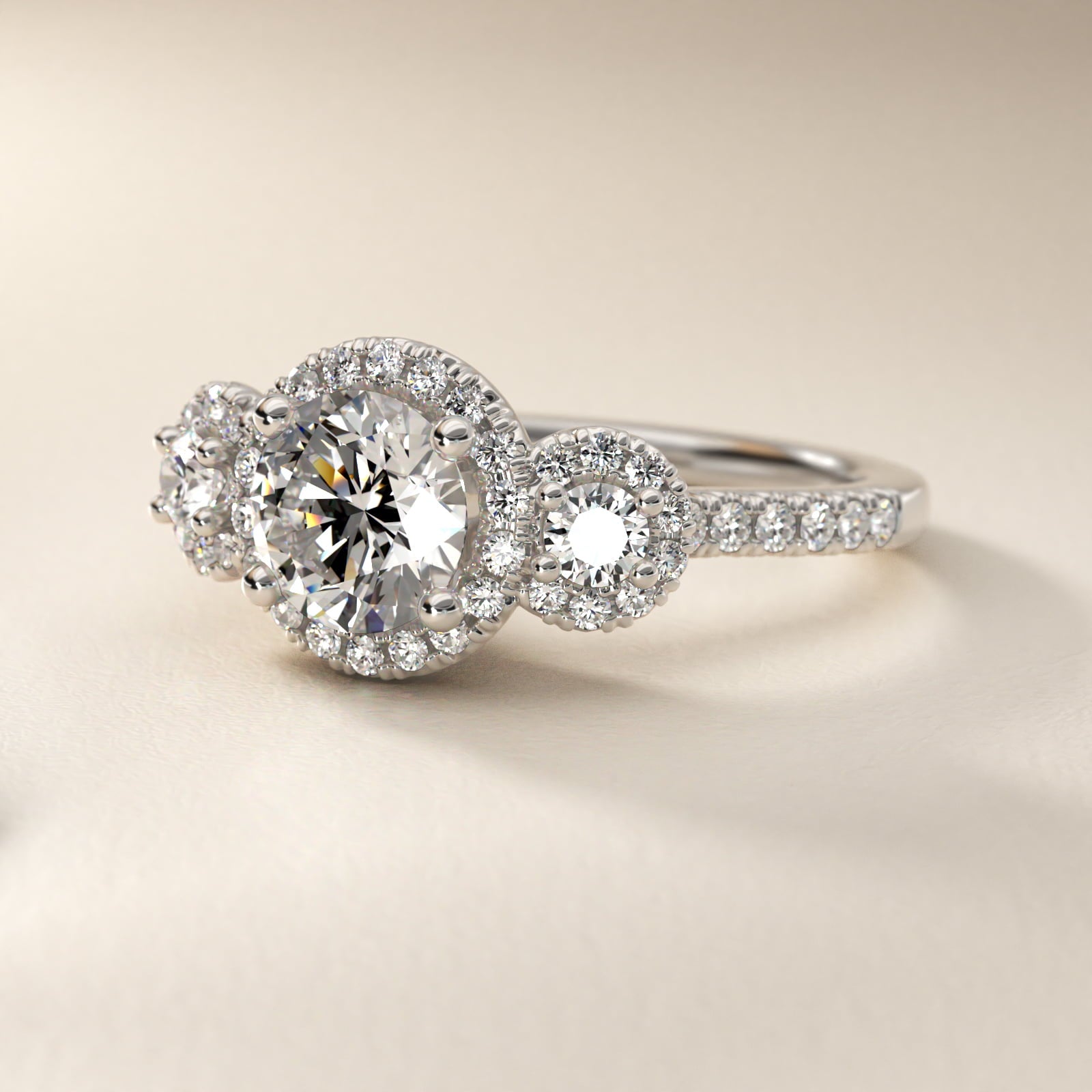 Three-Stone Halo Diamond Engagement Ring in Platinum - Round Center