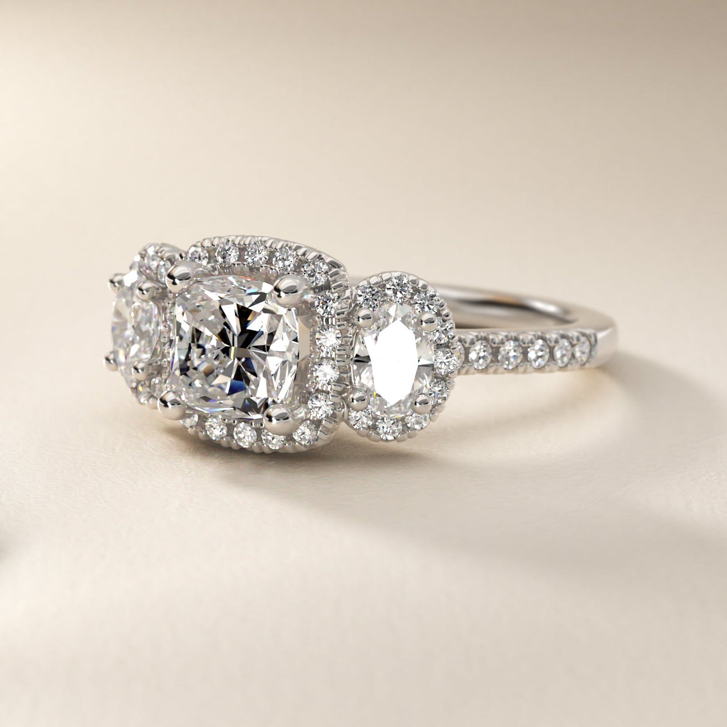 Three-Stone Oval Halo Diamond Engagement Ring in Platinum - Cushion Center