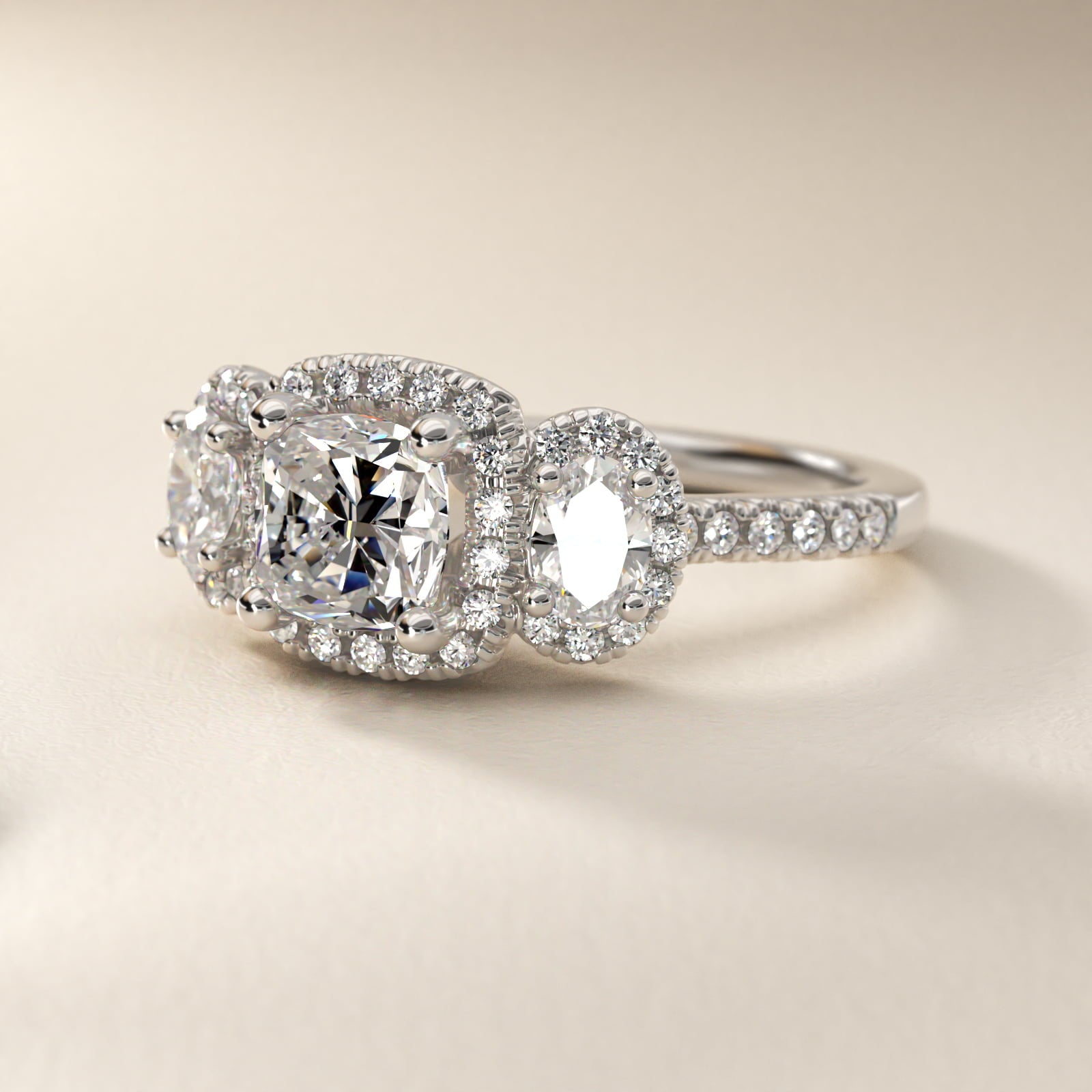 Three-Stone Oval Halo Diamond Engagement Ring in Platinum - Cushion Center