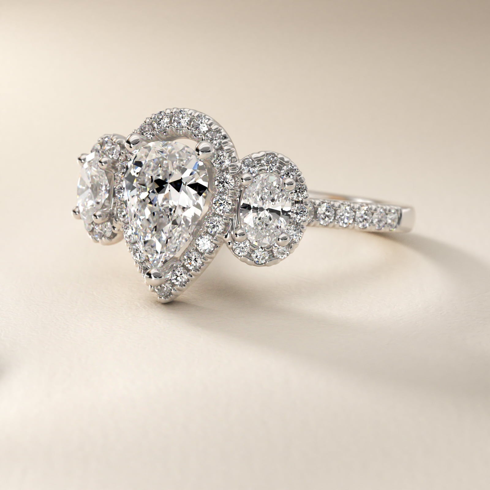Three-Stone Oval Halo Diamond Engagement Ring in Platinum - Pear Center
