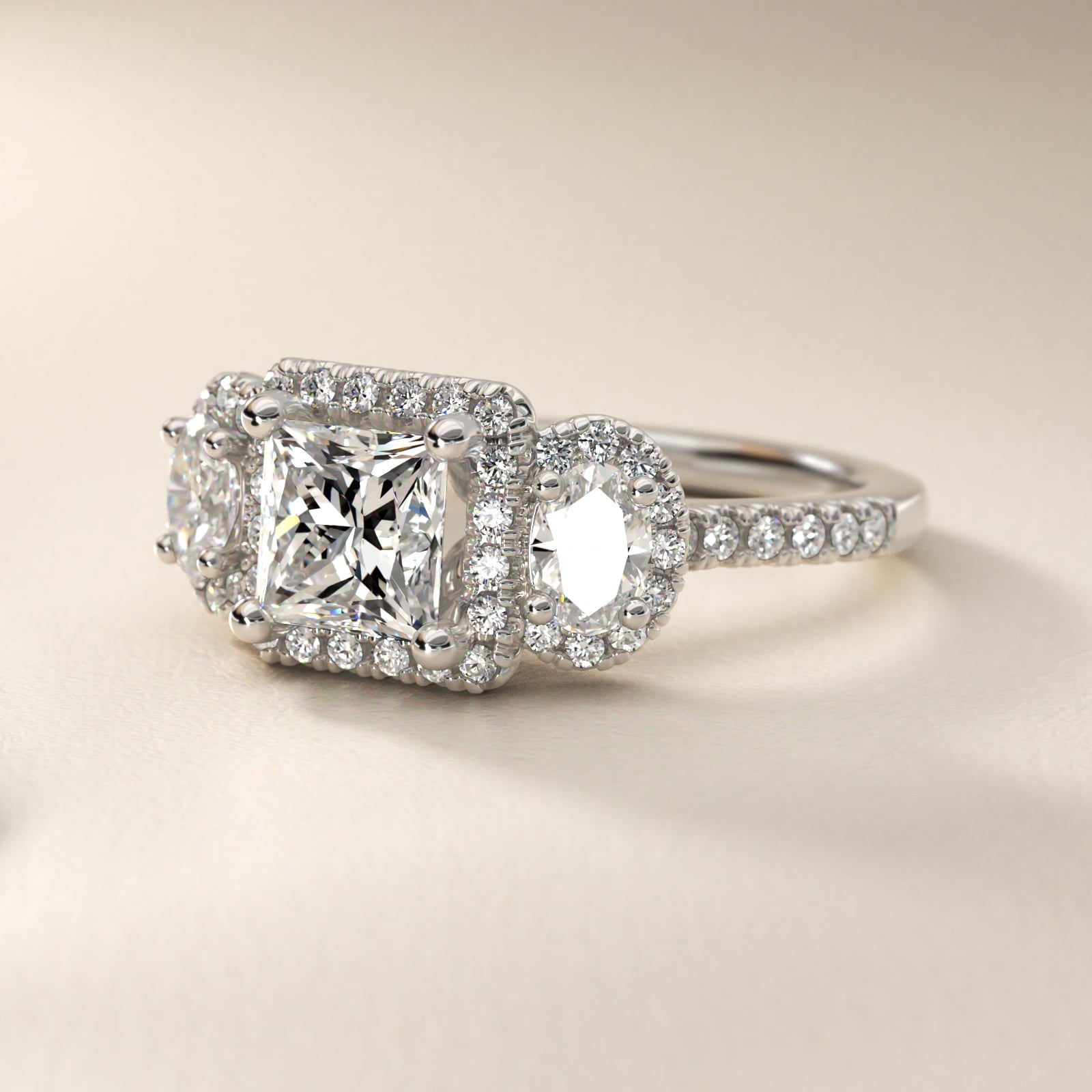 Three-Stone Oval Halo Diamond Engagement Ring in Platinum - Princess Center