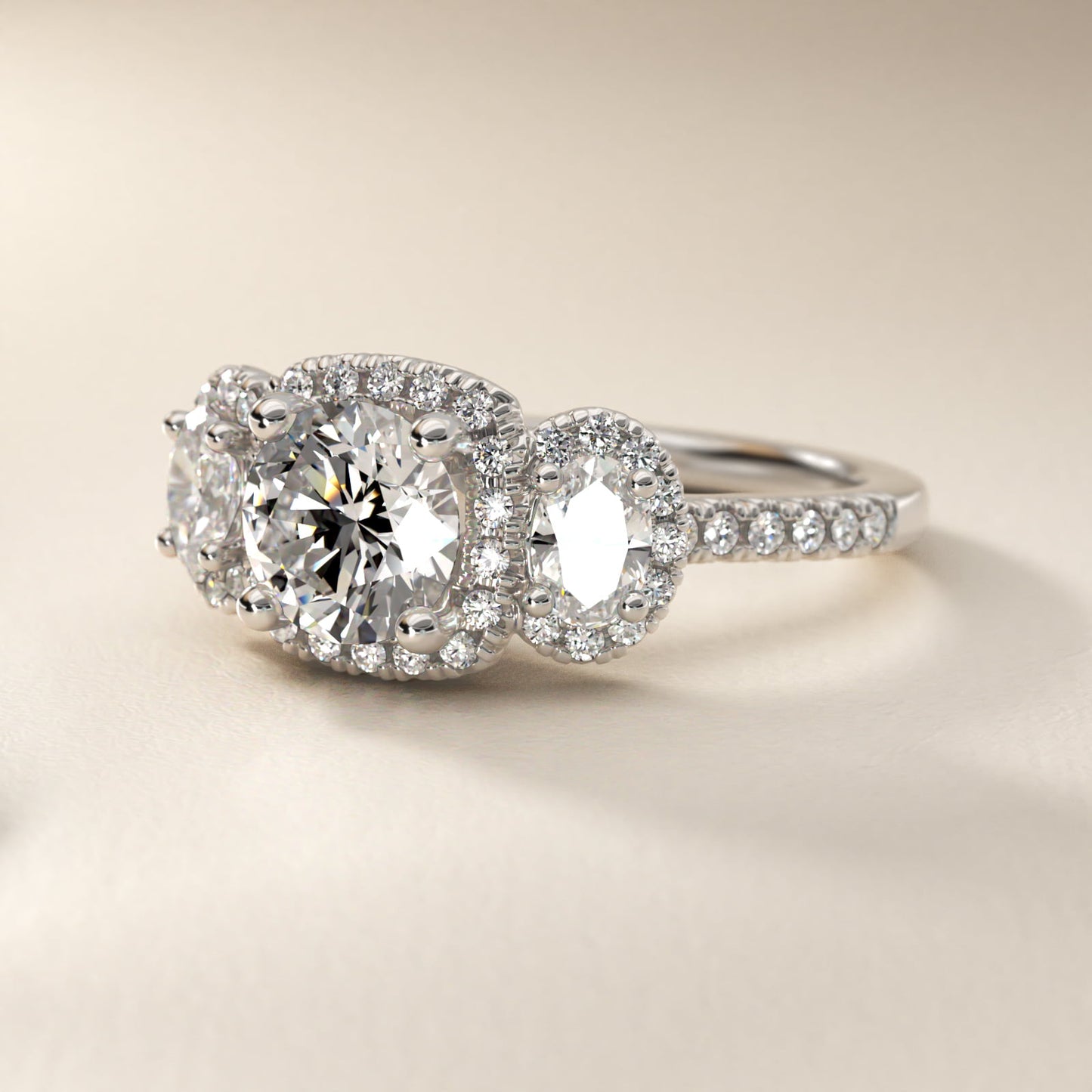 Three-Stone Oval Halo Diamond Engagement Ring in Platinum - Round Center