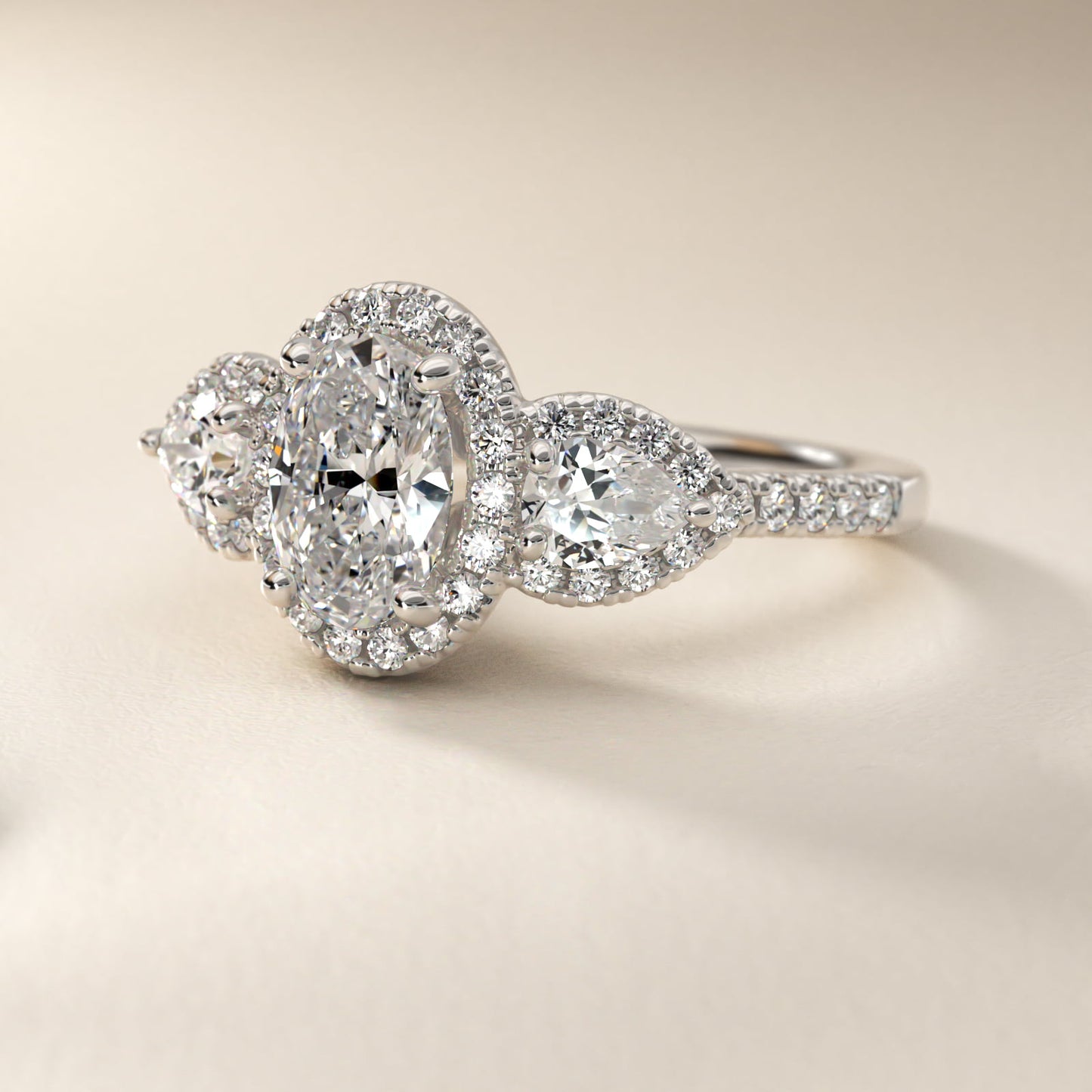 Three-Stone Pear Halo Diamond Engagement Ring in 18k White Gold - Oval Center