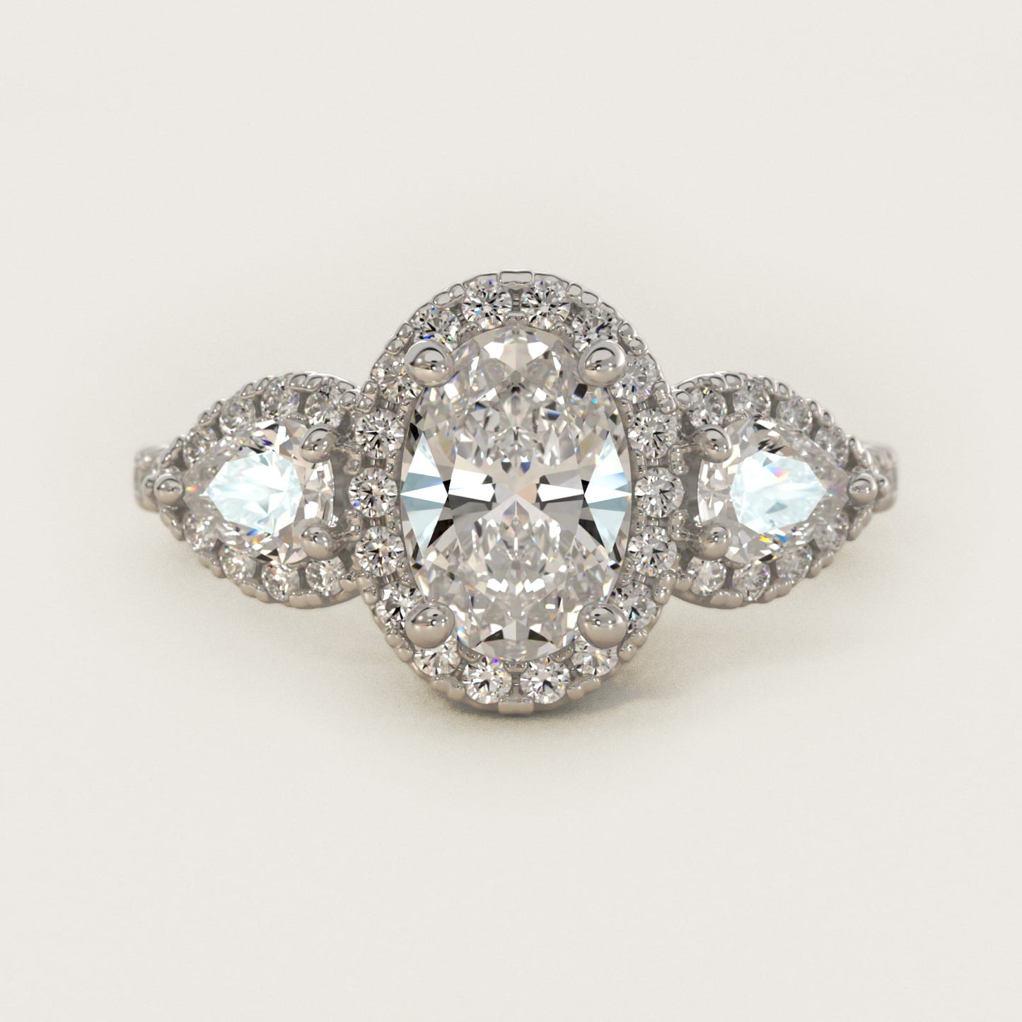 Three-Stone Pear Halo Diamond Engagement Ring in Platinum - Oval Center